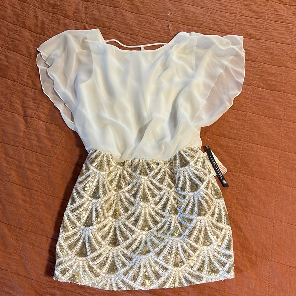 White dress with sequined bottom.